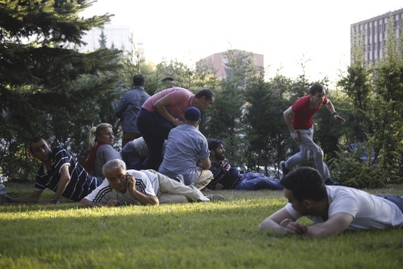 People take cover as shots are fired in Ankara, Turkey July 16, 2016. REUTERS/Tumay Berkin