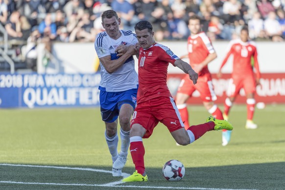 Switzerland&#039;s Granit Xhaka, right, scores against Faroe&#039;s Frodi Benjaminsen, left, during the 2018 Fifa World Cup Russia group B qualification soccer match between Switzerland and Faroe Isla ...