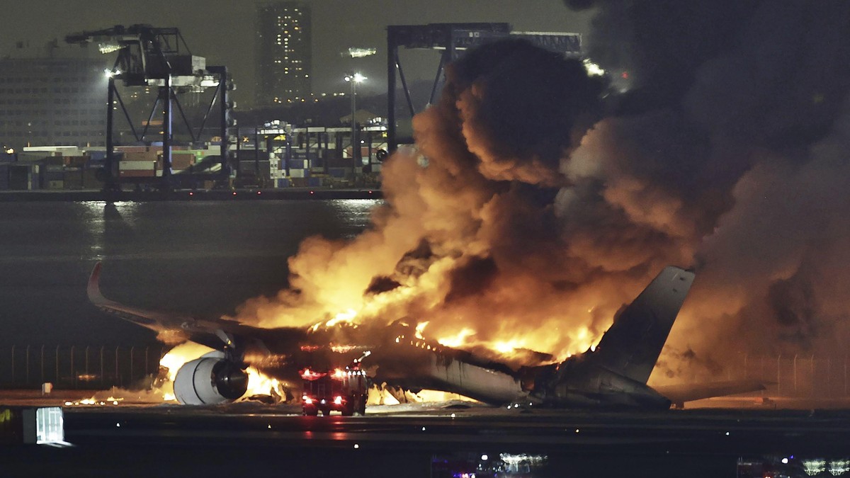 FILE - A Japan Airlines plane is on fire on the runway of Haneda airport in Tokyo, on Jan. 2, 2024. The 379 passengers of Japan Airlines Flight JAL-516 didn't expect their plane to burst into fla ...