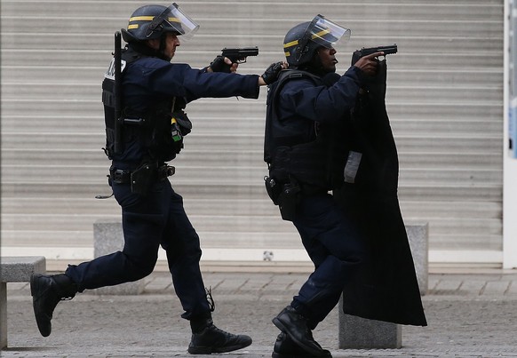 FILE - In this Nov. 18, 2015 file photo armed police operate in Saint-Denis, a northern suburb of Paris, Wednesday, Nov. 18, 2015. (AP Photo/Francois Mori)