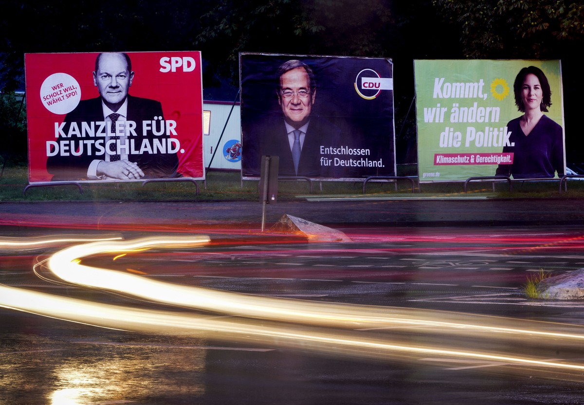 Three elections posters show Social Democratic top candidate for chancellor Olaf Scholz, left, Christian Democratic top candidate Armin Laschet, center, and top candidate of the Greens Annalena Baerbo ...
