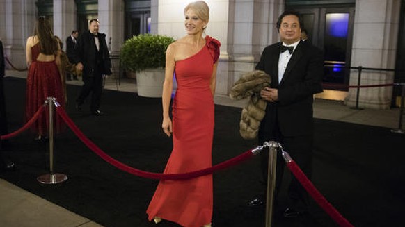 FILE - In this Thursday, Jan. 19, 2017 file photo, President-elect Donald Trump adviser Kellyanne Conway, center, accompanied by her husband, George, speaks with members of the media as they arrive fo ...