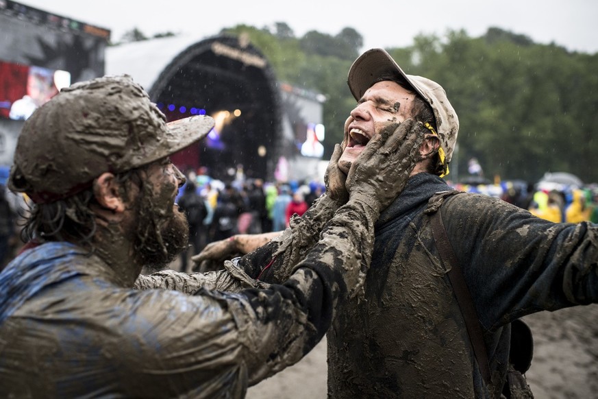 People dance in the mud during the music festival Openair St. Gallen, on Saturday, July 2, 2016, in St. Gallen. The 40th Openair St. Gallen takes place until Sunday, July 3, 2016. (Keystone/Gian Ehren ...