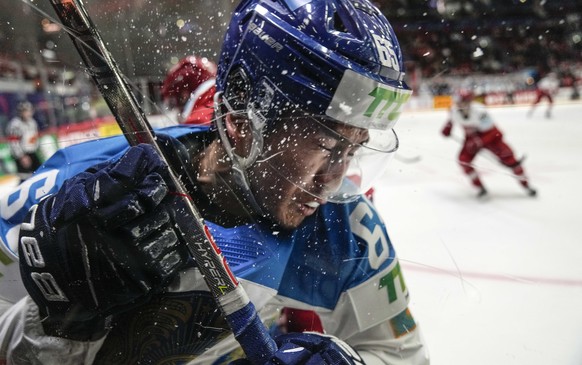 Samat Daniyar of Kazakhstan hits the window during the group A Hockey World Championship match between Denmark and Kazakhstan in Helsinki, Finland, Saturday May 14, 2022. (AP Photo/Martin Meissner)