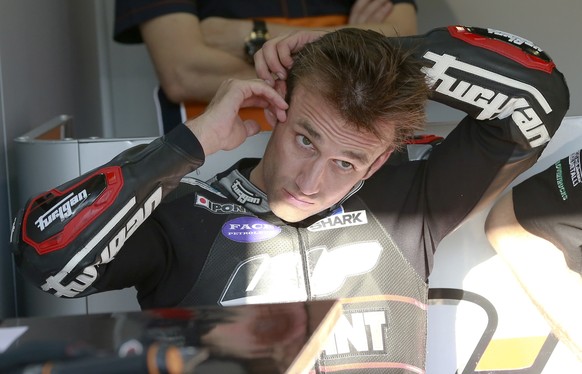 Moto2 driver Johann Zarco of France puts an earplug during the qualifying session for the MotoGP Japanese Motorcycle Grand Prix at the Twin Ring Motegi circuit in Motegi, north of Tokyo, Saturday, Oct ...