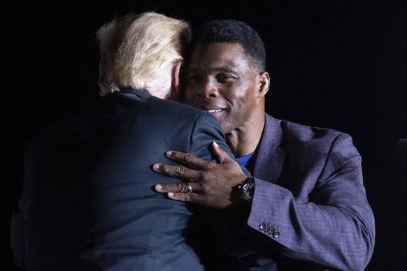 Former President Donald Trump hugs Georgia Senate candidate Herschel Walker during his Save America rally in Perry, Ga., on Saturday, Sept. 25, 2021. (AP Photo/Ben Gray)