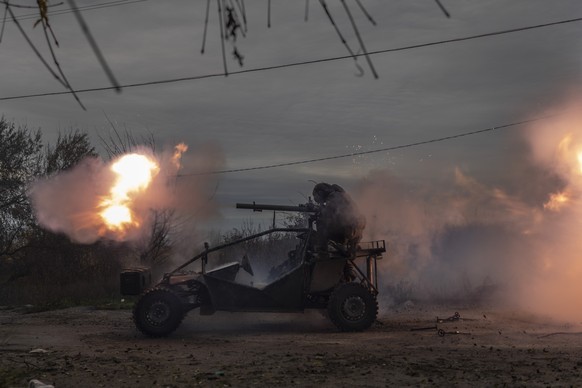 Ukrainian servicemen fire toward Russian positions in the frontline near Kherson, southern Ukraine, Wednesday, Nov. 23, 2022. (AP Photo/Bernat Armangue)