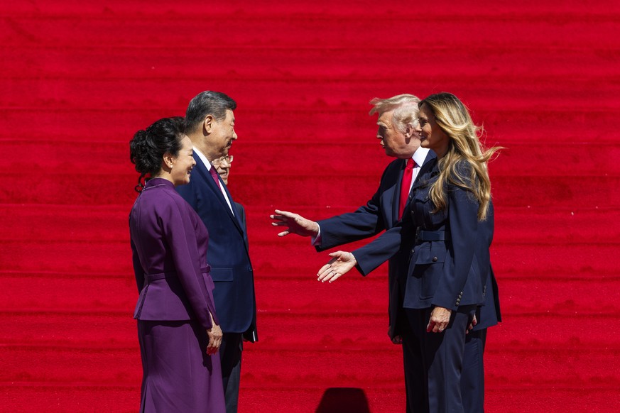 epa13263079 US President Donald Trump (C-R) and First Lady Melania Trump (R) escort Chinese President Xi Jinping (C-L) and First Lady of China Peng Liyuan (L) from the National Archives in Washington, ...