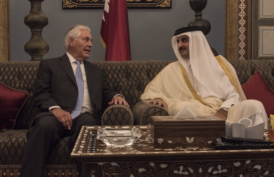 epa06081053 A handout photo made available by the US Department of State shows US Secretary of State Rex Tillerson (L) meeting with the Emir of Qatar, Sheikh Tamim Bin Hamad Al Thani at Sea Palace in  ...