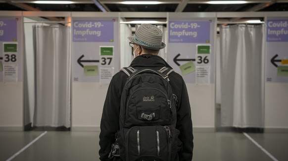 A man waits to get COVID-19 vaccine in Vienna, Austria, Monday, Nov. 22, 2021. Austria went into a nationwide lockdown early Monday to combat soaring coronavirus infections, a step being closely watch ...