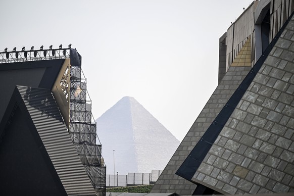 KEYPIX - epa12496878 The Pyramid in Giza (C) is seen in the distance from the Grand Egyptian Museum before the official opening of the museum in Giza, Egypt, 01 November 2025. The Grand Egyptian Museu ...