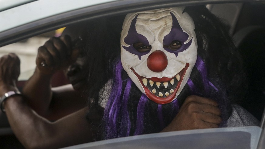 A passenger sits in a car wearing a mask, which he said was to prevent him catching the new coronavirus, in Lagos, Nigeria Friday, March 27, 2020. The new coronavirus causes mild or moderate symptoms ...