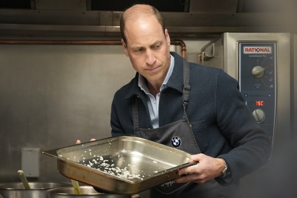 Britain&#039;s Prince William helps make bolognase sauce during a visit to Surplus to Supper, in Sunbury-on-Thames, Surrey, England, Thursday, April 18, 2024. The Prince visited Surplus to Supper, a s ...