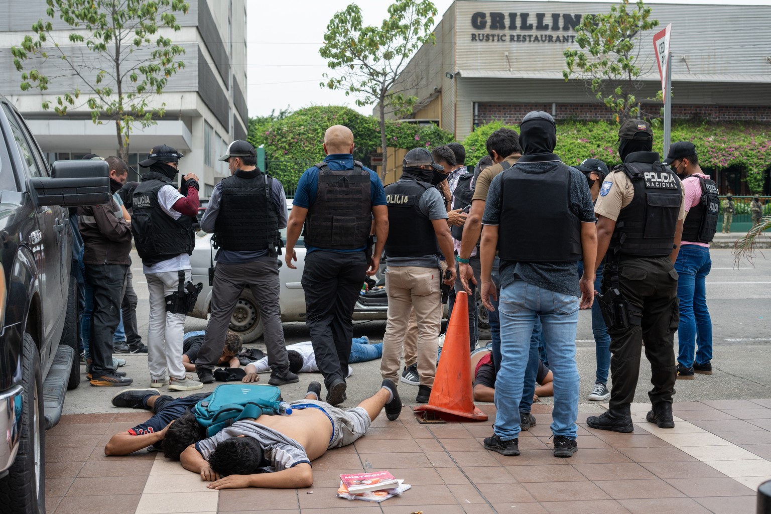 epa11066688 Police detain suspected criminals a few blocks from the headquarters of TC television station where armed, hooded men entered and subdued staff during a live broadcast, in Guayaquil, Ecuad ...