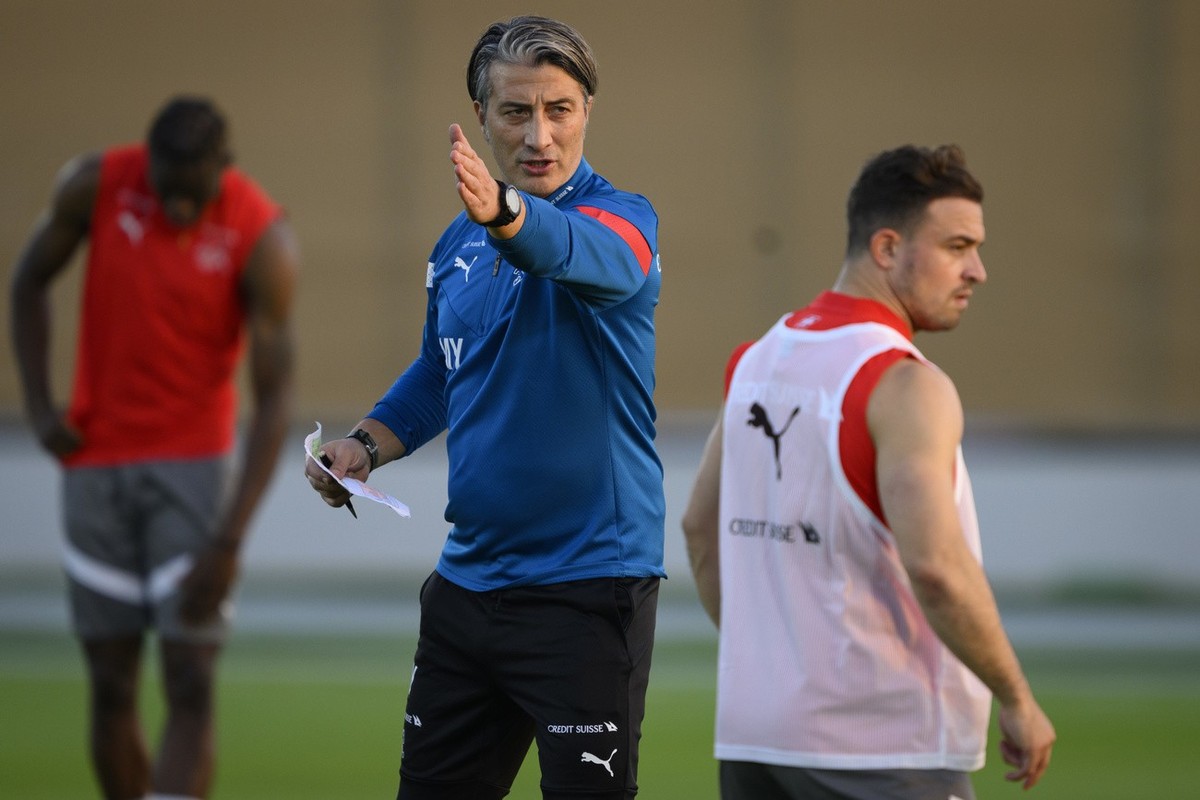 Switzerland's head coach Murat Yakin, center, and Switzerland's midfielder Xherdan Shaqiri, right, attend a open training session of Swiss national team in preparation for the FIFA World Cup ...