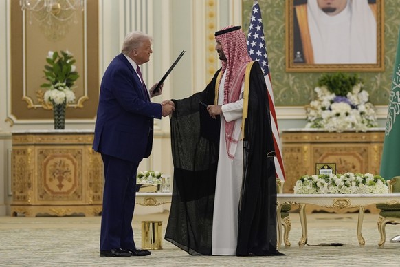 KEYPIX - President Donald Trump and Saudi Crown Prince Mohammed bin Salman shake hands after exchanging documents during a signing ceremony at the Royal Palace in Riyadh, Saudi Arabia, Tuesday, May 13 ...