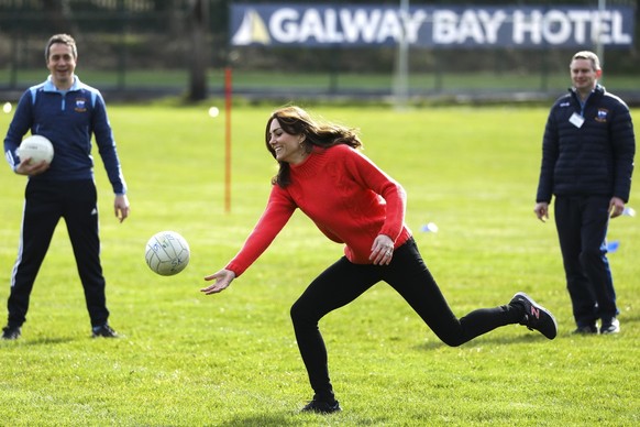 Kate the Duchess of Cambridge, centre, plays Gaelic football at Salthill Knocknacarra GAA Club in Galway, Ireland, Thursday, March 5, 2020. The Duke and Duchess of Cambridge visit Galway on the last o ...