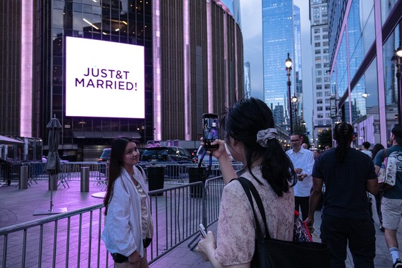 epa13084930 'Swifties', Taylor Swift fans, take photos outside Madison Square Garden during Taylor Swift and Travis Kelce's wedding celebration in New York, New York, USA, 03 July 2026. ...