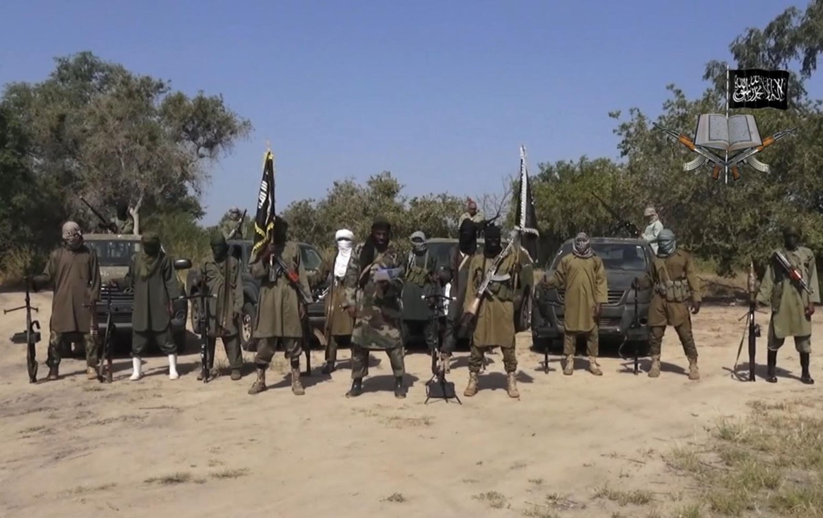 FILE - In this file image taken from video released late Friday evening, Oct. 31, 2014, by Boko Haram, Abubakar Shekau, centre, the leader of Nigeria's Islamic extremist group sorrounded by his f ...