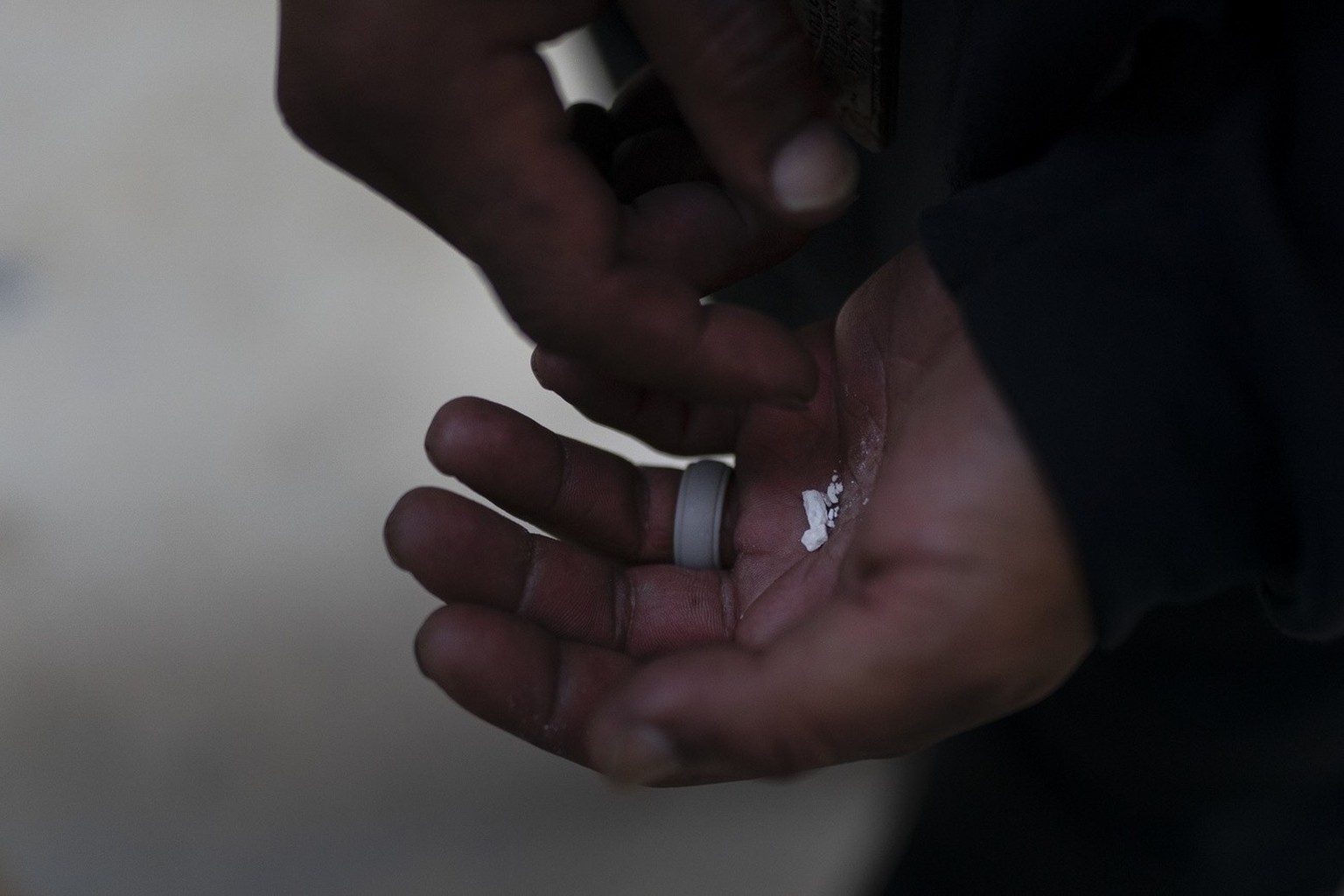 A homeless addict holds pieces of fentanyl in Los Angeles, Thursday, Aug. 18, 2022. Use of the powerful synthetic opioid that is cheap to produce and is often sold as is or laced in other drugs, has e ...