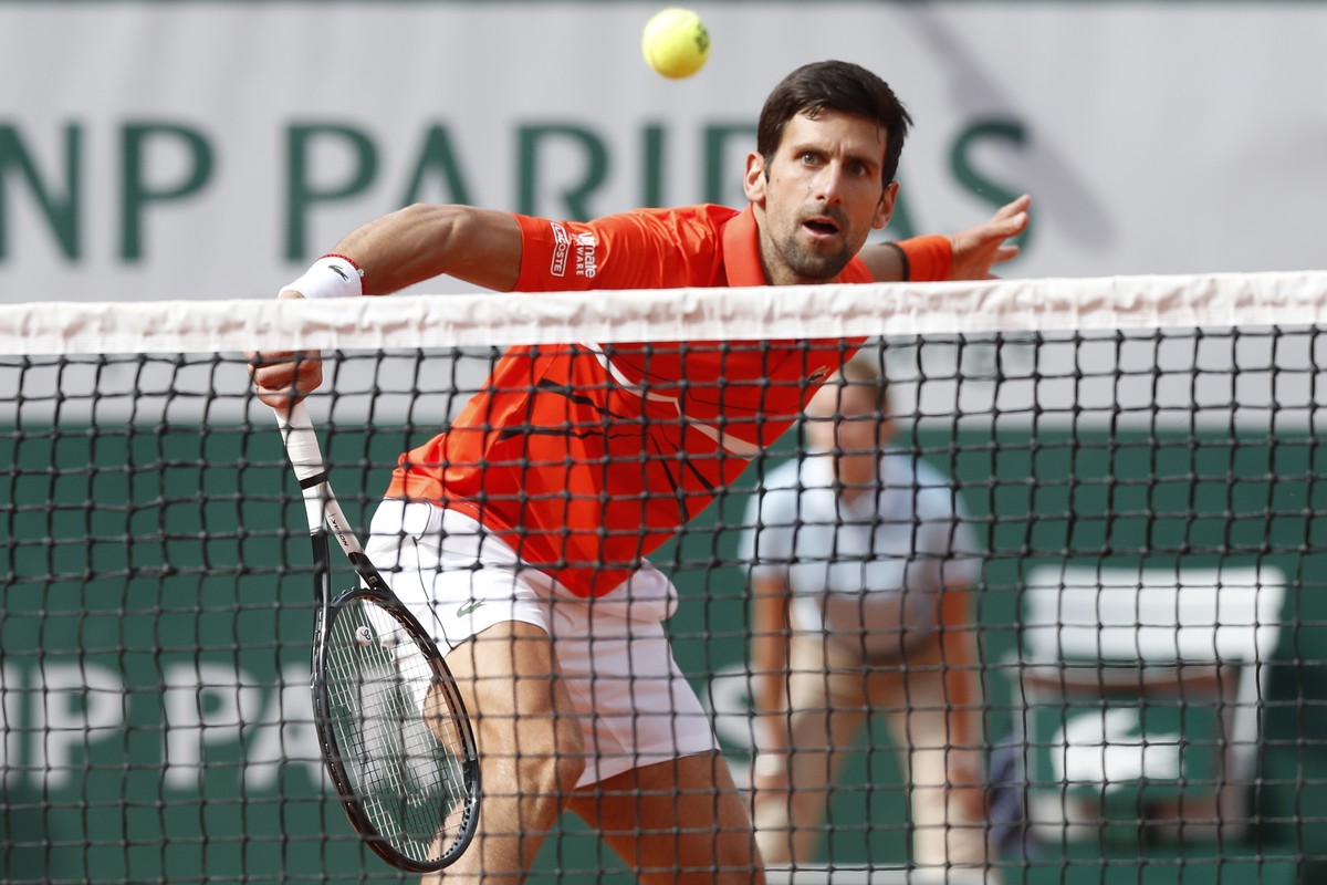 Serbia's Novak Djokovic plays a shot against Poland's Hubert Hurkacz during their first round match of the French Open tennis tournament at the Roland Garros stadium in Paris, Monday, May 27 ...