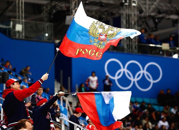 epa09792091 (FILE) - Russian fans wave flags during the men&#039;s preliminary round ice hockey match between Russia and the USA inside the Gangneung Hockey Centre at the PyeongChang Winter Olympic Ga ...