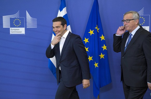 Greek Prime Minister Alexis Tsipras (L) is welcomed by European Commission President Jean Claude Juncker (R) for a meeting ahead of a Eurozone emergency summit on Greece in Brussels, Belgium June 22,  ...
