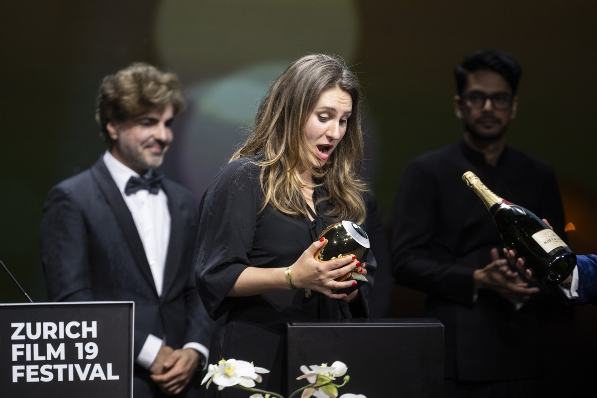 epa10906539 Kseniia Marchenko (C) accepts the award on behalf of Maciek Hamela for his movie 'In the rearview' during the Award Night ceremony of 19th Zurich Film Festival (ZFF) in Zurich, S ...