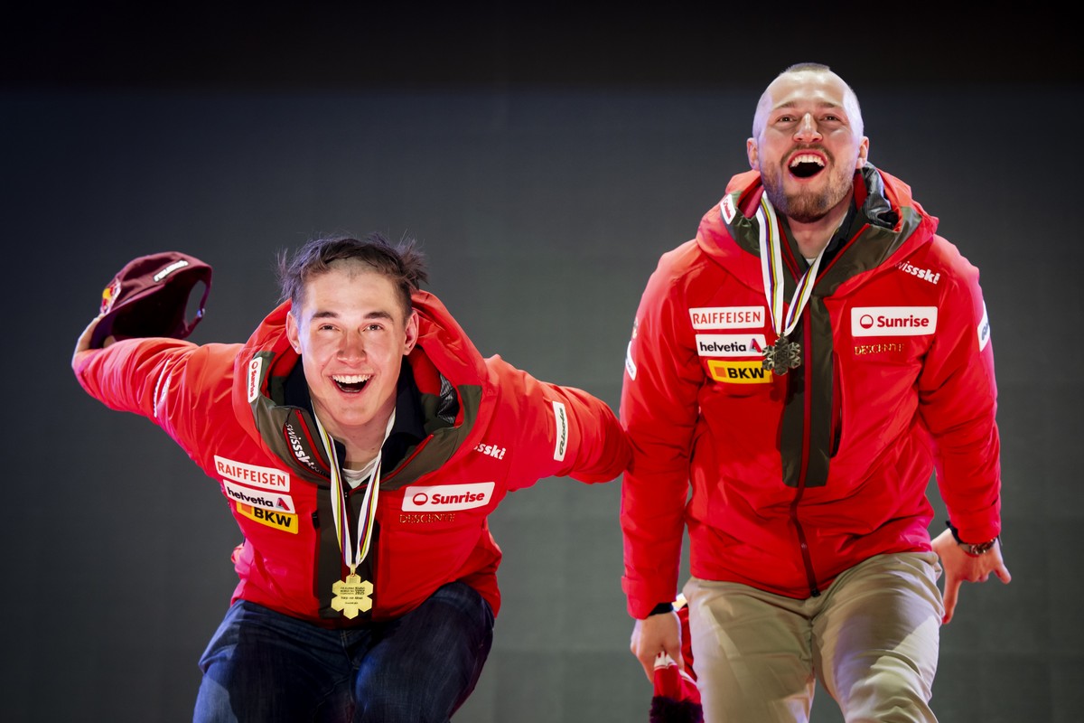 Gold medalist Franjo von Allmen, left, and Bronze medalist Alexis Monney of Switzerland, right, celebrate with their medals during the medals ceremony of the men's Downhill race at the 2025 FIS A ...