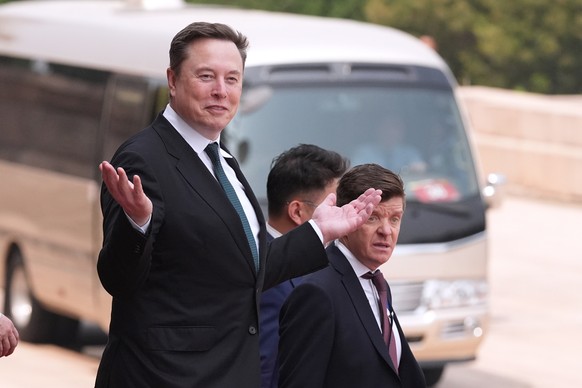 Elon Musk departs after a welcome ceremony with President Donald Trump and China's President Xi Jinping at the Great Hall of the People, Thursday, May 14, 2026, in Beijing. (AP Photo/Mark Schiefe ...