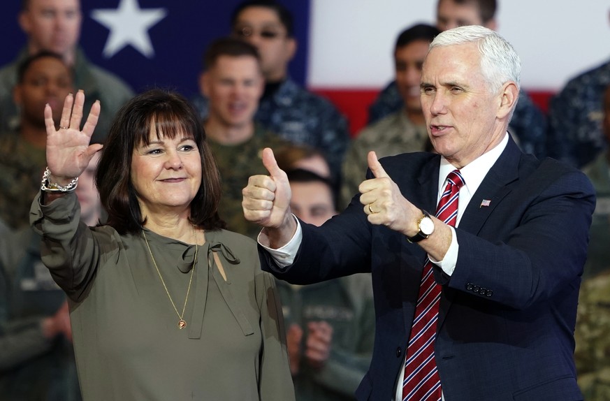 U.S. Vice President Mike Pence and his wife Karen waves to the U.S. troops at the U.S. Yokota Air Base, on the outskirts of Tokyo, Thursday, Feb. 8, 2018. (AP Photo/Shizuo Kambayashi, Pool)