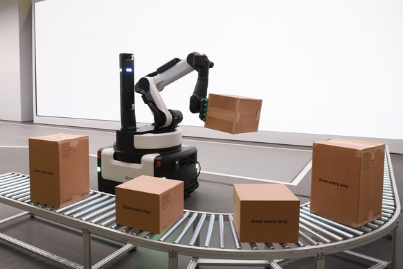 epa11068081 An autonomous loading and unloading robot made by Boston Dynamics picks up a package at the Hyundai booth at the 2024 Consumer Electronics Show at the Las Vegas Convention Center in Las Ve ...