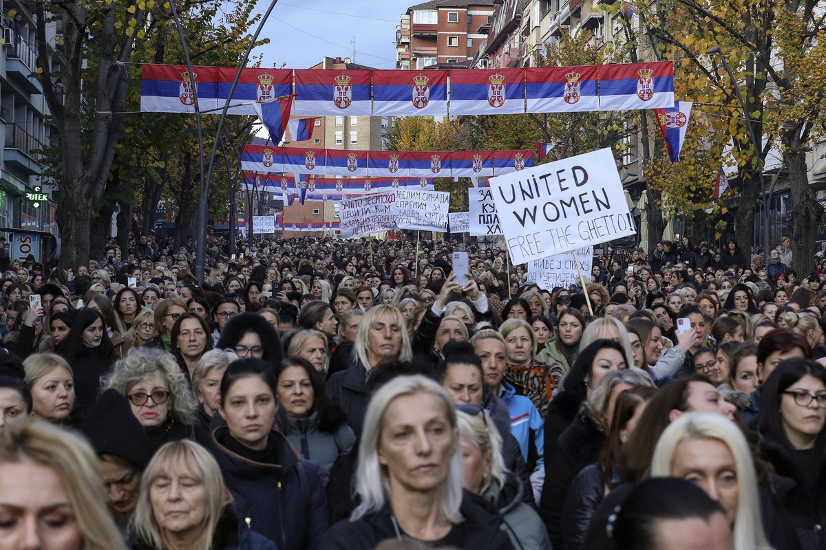 Women hold Serbia's flag as they march in the northern part of Kosovska Mitrovica, Kosovo, Wednesday, Nov. 23, 2022. Serbs in the northern part of Kosovska Mitrovica protested against planned fin ...