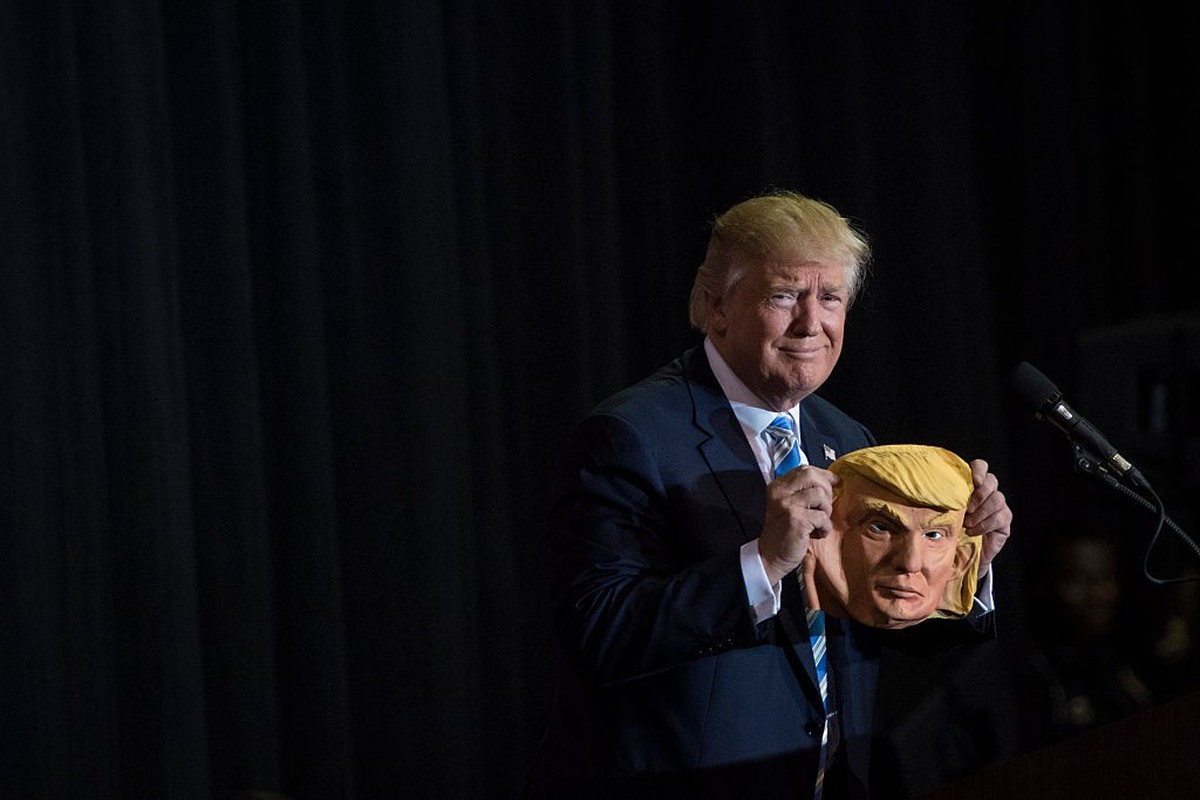 SARASOTA, FL - NOVEMBER 7: Republican presidential candidate Donald Trump holds up a mask depicting himself as he speaks during a campaign event at Robarts Arena at the Sarasota County Fairgrounds in  ...