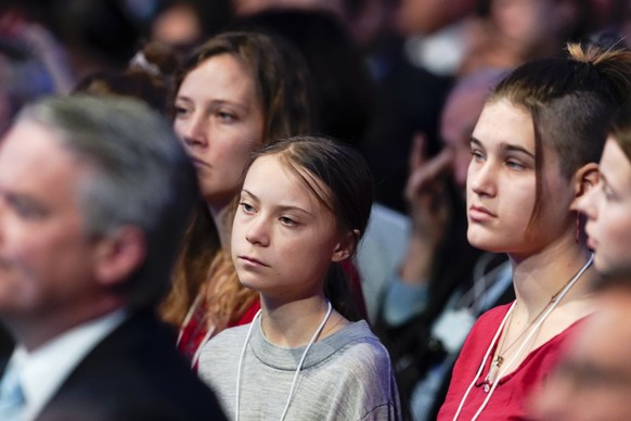 epa08146958 Swedish environmental activist Greta Thunberg (C) listens to a speech by US President Donald J. Trump at a plenary session during the 50th annual meeting of the World Economic Forum (WEF)  ...