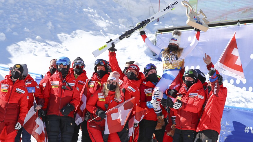 epa09008803 Winner Corinne Suter (top) of Switzerland celebrates with her team members after the Women's Downhill race at the Alpine Skiing World Championships in Cortina d'Ampezzo, Italy, 13 February ...