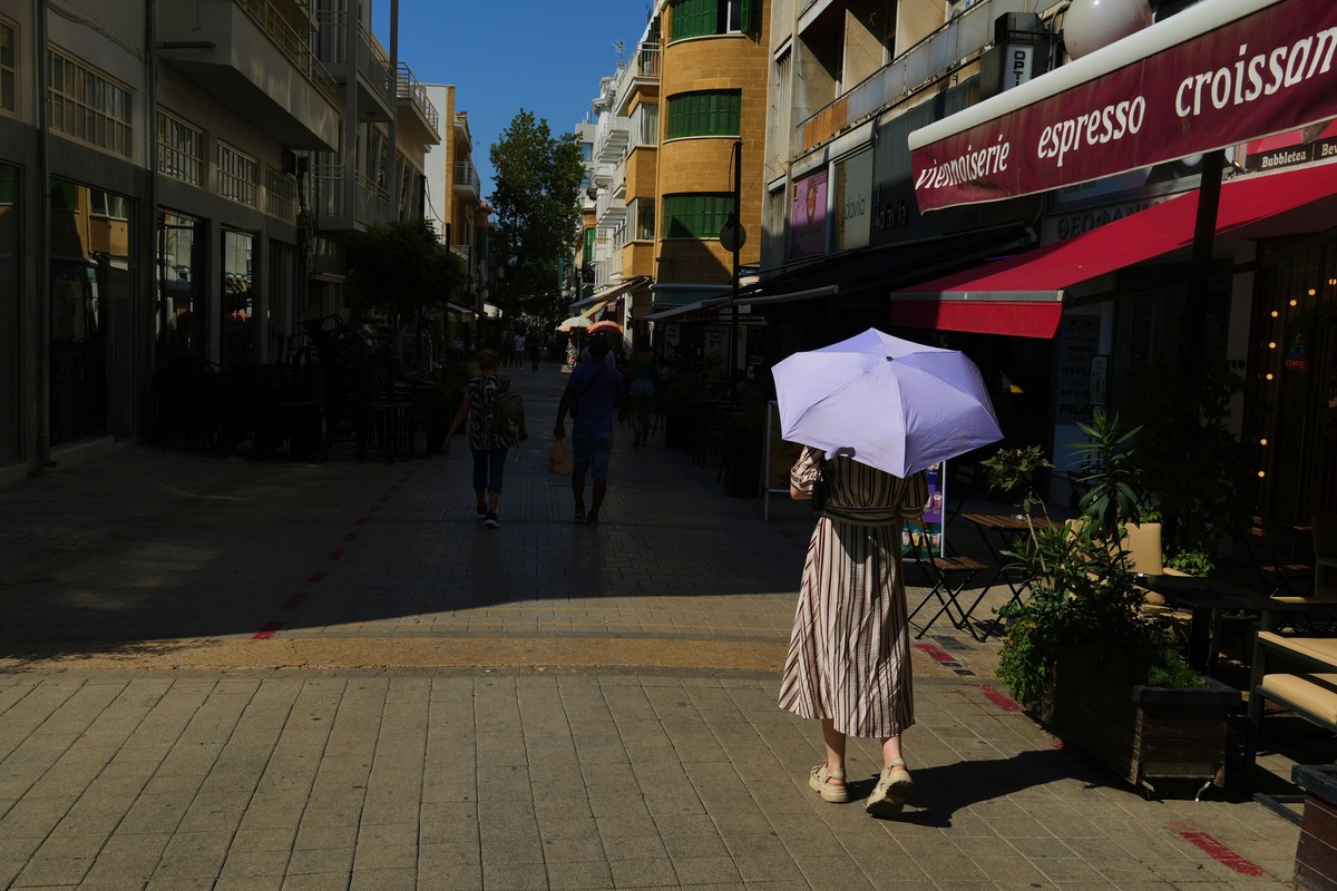A woman shelters from the sun with an umbrella during a heat wave in central Nicosia, Cyprus, Friday, Aug. 21, 2026. (AP Photo/Petros Karadjias)
Cyprus Extreme Weather Heat