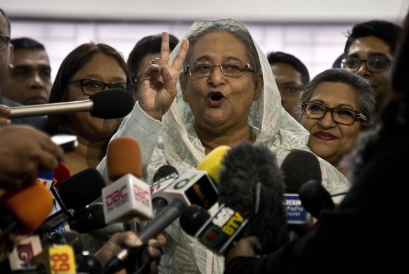 Bangladesh Prime Minister Sheikh Hasina flashes a victory sign as she speaks to the media persons after casting her vote in Dhaka, Bangladesh, Sunday, Dec. 30, 2018. Voting began Sunday in Bangladesh& ...