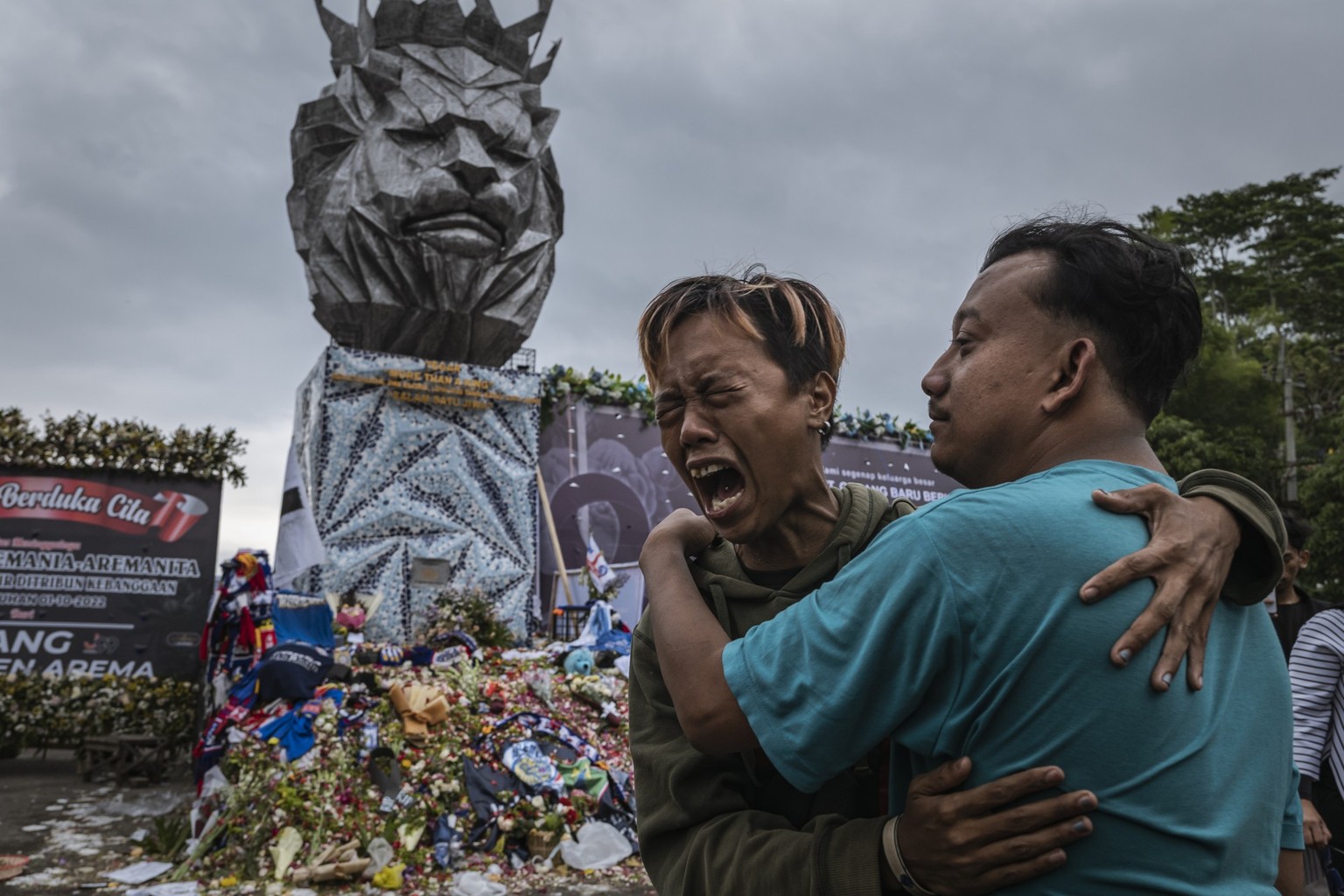 MALANG, INDONESIA - OCTOBER 05: Supporters of Arema FC react as they pay condolence to the victims who were killed during the riot and stampede after a football match between Arema FC and Persebaya Su ...