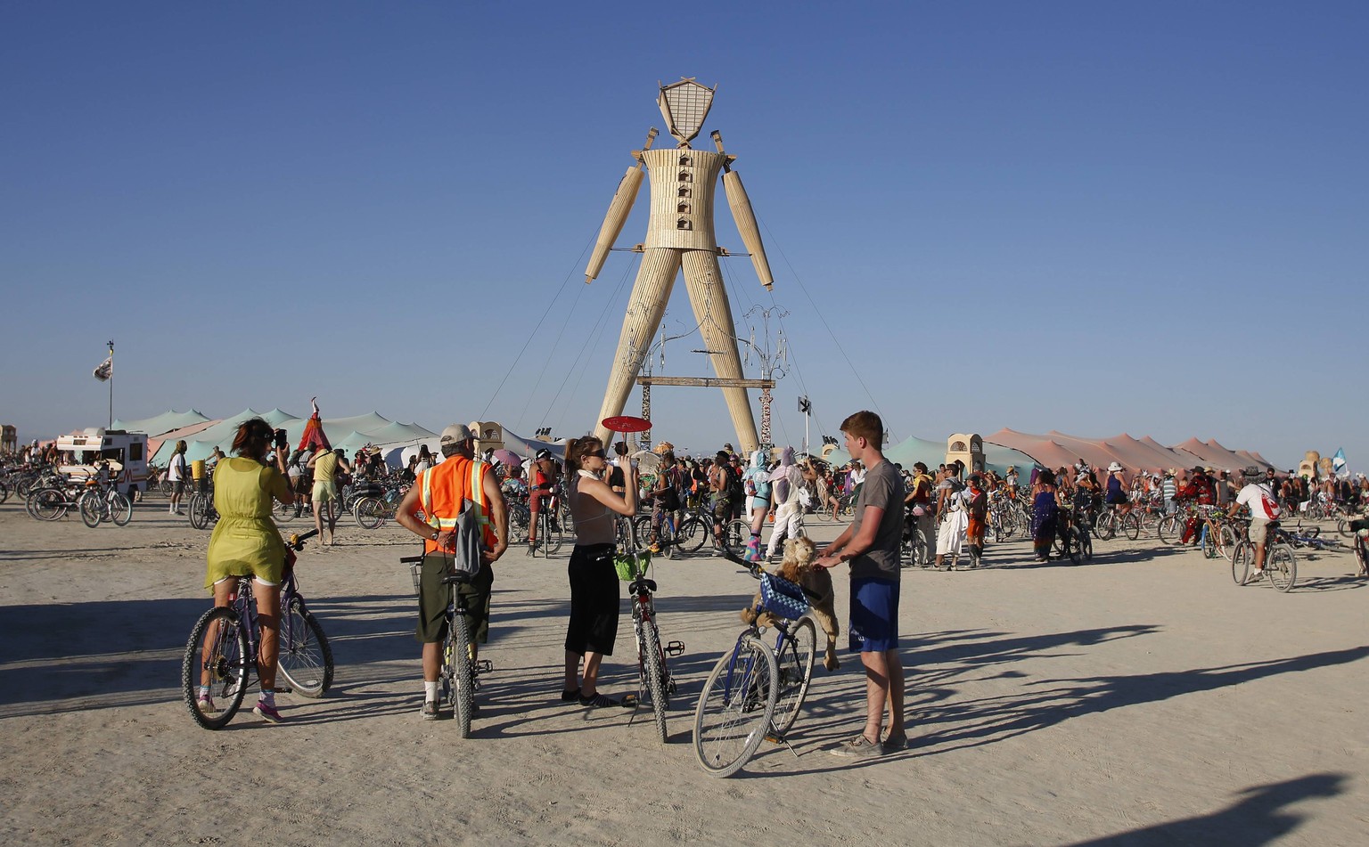 People gather at the man structure during the Burning Man 2014 &quot;Caravansary&quot; arts and music festival in the Black Rock Desert of Nevada, August 27, 2014. People from all over the world have  ...