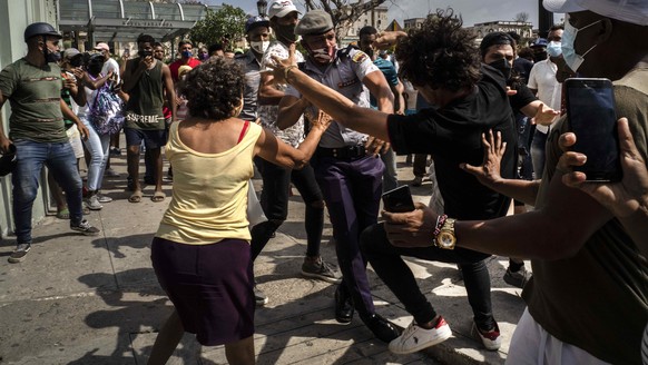 Police detain an anti-government demonstrator during a protest in Havana, Cuba, Sunday July 11, 2021. Hundreds of demonstrators went out to the streets in several cities in Cuba to protest against ong ...
