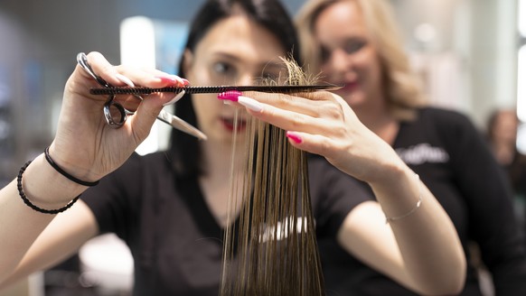 ZUR BERUFSAUSBILDUNG DER COIFFEUSE STELLEN WIR IHNEN FOLGENDES NEUES BILDMATERIAL ZUR VERFUEGUNG --- Hairdresser apprentices of the hairstyling company Coiffina cut and style hair under the supervisio ...