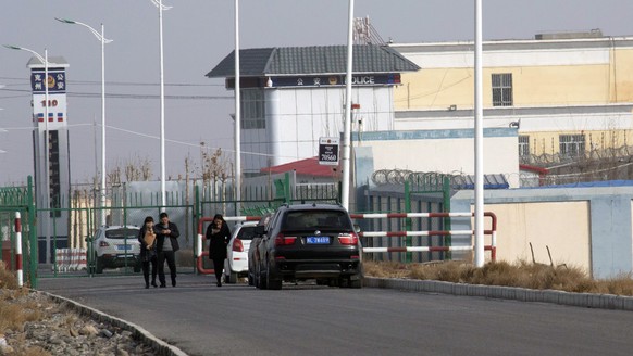 FILE - In this Dec. 3, 2018, file photo, people walk by a police station by the front gate of the Artux City Vocational Skills Education Training Service Center in Artux in western China&#039;s Xinjia ...