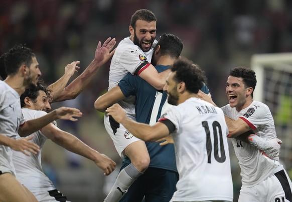 Egypt's captain Mohamed Salah and eammates celebrates after scoring the winning penalty, of the African Cup of Nations 2022 round of 16 soccer match between Ivory Coast and Egypt at the Japoma Stadium in Douala, Cameroon, Wednesday, Jan. 26, 2022. Egypt beat Ivory Coast 5-4 on penalties. (AP Photo/Themba Hadebe)