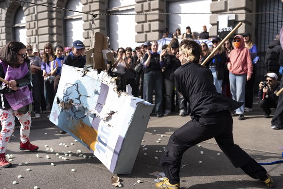 Women hold placards and shout slogans during a protest marking the International Women's Day in Zurich, Switzerland, Saturday, March 7, 2026. Feminist Strike Zurich called on people to demonstrat ...