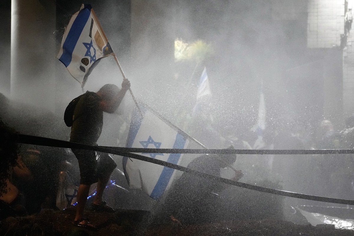 Police uses a water canon against demonstrators during a protest against plans by Netanyahu's government to overhaul the judicial system, in Tel Aviv, Monday, July 24, 2023. Israeli lawmakers on  ...