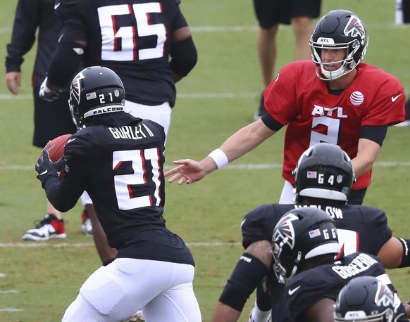 Atlanta Falcons quarterback Matt Ryan hands off to running back Todd Gurley during an NFL football training camp practice in Flowery Branch, Ga., Monday, Aug. 24, 2020. (Curtis Compton/Atlanta Journal ...