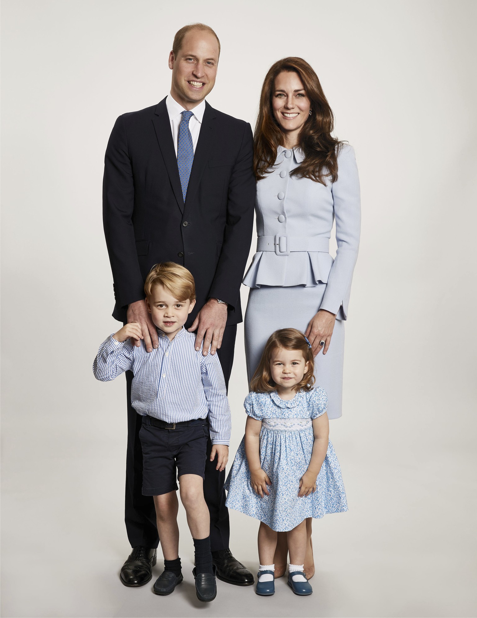 In this undated photo provided by Kensington Palace on Monday, Dec. 18, 2017, Britain&#039;s Prince William, background left and Kate, the Duchess of Cambridge pose with their children Prince George a ...