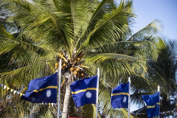 FILE - This shows national flags in Nauru for the Pacific Islands Forum on the tiny Pacific nation of Nauru, on Sept. 3, 2018. The Pacific Island nation of Nauru says it is switching diplomatic recogn ...