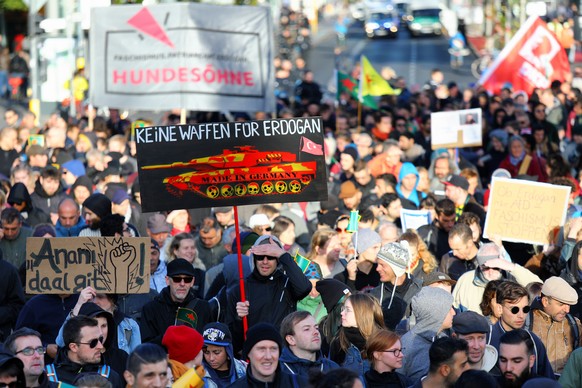 epa07054843 A man holding a placard reading &#039;No weapons for Erdogan&#039; (front) participates in a demonstrationagainst the Turkish president, in Berlin, Germany, 28 September 2018. The demonstr ...